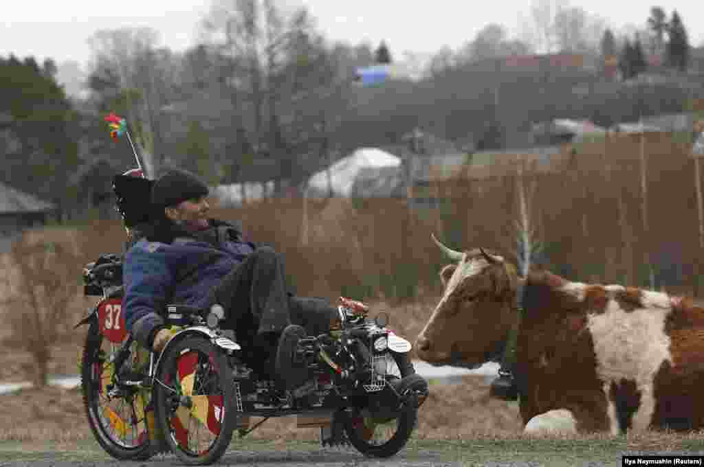 Aleksei Seryogin, 50, rides a three-wheeled velomobile which he designed and made himself, in the Siberian village of Balakhta in Russia's Krasnoyarsk region. (Reuters/Ilya Naymushin)