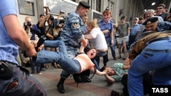 Police detain protesters during a March of Dissent in Moscow -- typical of the dialogue between civil society and the authorities in Russia?