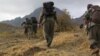 Kurdistan Workers Party (PKK) fighters walk in mountains from Turkey through the border with Iraq in early May.