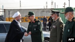 A handout picture provided by the Iranian presidency on September 22, 2019 shows (L to R) President Hassan Rouhani shaking hands with Iranian Armed Forces Chief of Staff Major General Mohammad Hossein Bagheri, before Commander-in-Chief of the Islamic Repu