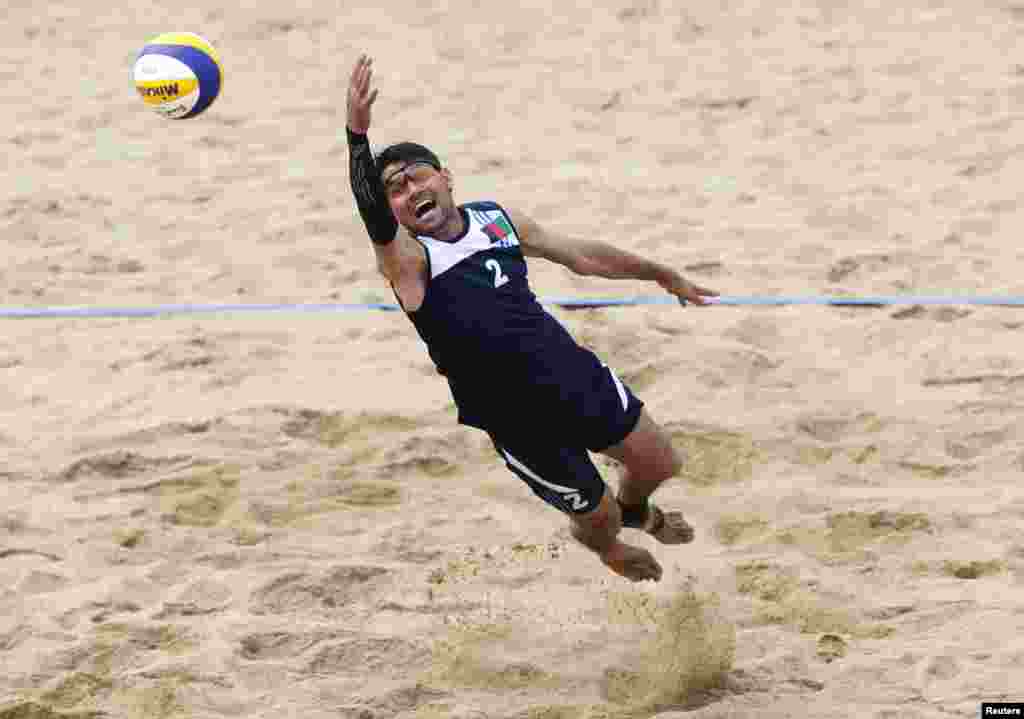 Afghanistan's Ali Mohammad Mohammad Zaker reaches for the ball during a match against Indonesia in the men's beach volleyball competition at Songdo Global University during the 17th Asian Games in Incheon, South Korea. (Reuters/Olivia Harris)