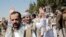 Yemeni prisoners chant slogans during their arrival after being released by the Saudi-led coalition at the airport in Sanaa, Yemen, Thursday, Oct. 15, 2020. (AP Photo/Hani Mohammed)