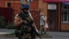 A Ukrainian serviceman patrols in the Russian town of Sudzha, which Kyiv seized control of this month. 