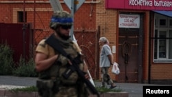 A Ukrainian soldier patrols an area of the Russian town of Sudzha controlled by the Ukrainian Army in the Kursk region on August 16.