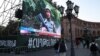 Armenia -- A big screen placed at Yerevan's Republic Square shows a state TV report on the war in Nagorno-Karabakh, October 9, 2020. 