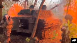 In this photo taken from a video released by the Russian Defense Ministry press service on October 30, a Russian howitzer fires toward Ukrainian positions in the Kursk border area of Russia.