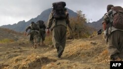 Kurdistan Workers Party (PKK) fighters walk in mountains from Turkey through the border with Iraq in early May.