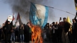 Supporters of the Iranian Islamic republic burn a painted Israeli flag in Tehran on October 2 during a gathering to support the missile attack on Israel the previous day.