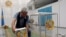 A member of a local election committee prepares a ballot-box in an electoral district at Kazakh's ca