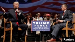 Republican presidential nominee Donald Trump (left) speaks alongside retired U.S. Army Lieutenant General Michael Flynn during a campaign town hall meeting in Virginia Beach, Virginia, in September 2016.