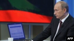 Vladimir Putin listens to a question during an annual televised phone-in show in Moscow in 2009.