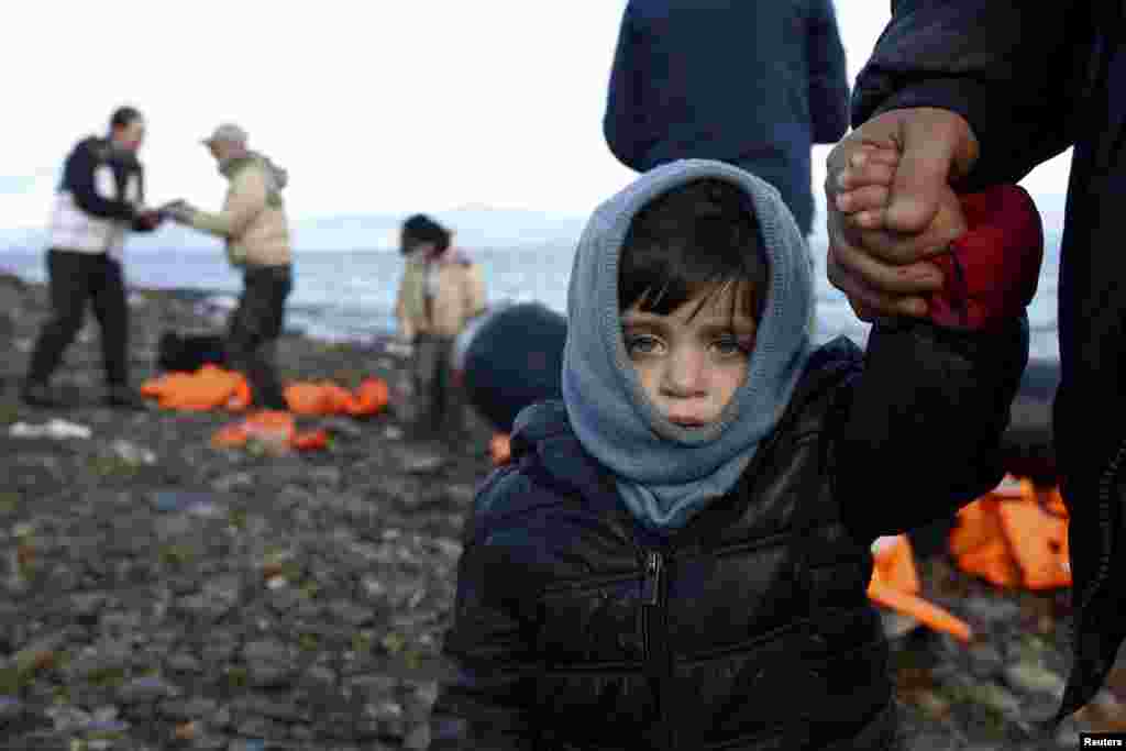 A Syrian refugee child looks on, moments after arriving on a raft with other Syrian refugees on a beach on the Greek island of Lesbos. (Reuters/Giorgos Moutafis)