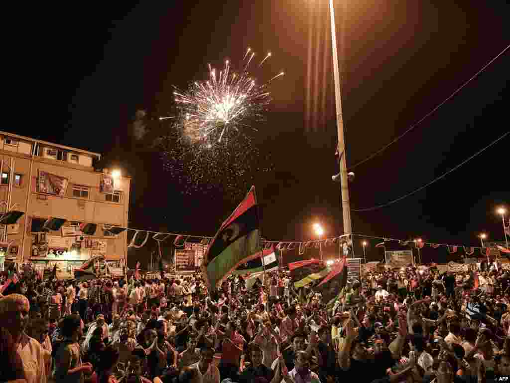 Fireworks light the skies late into the night as Libyans celebrate the fall of Qaddafi in the eastern city of Benghazi.