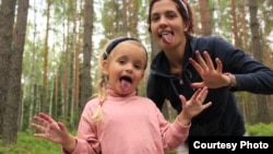 Happier times: Jailed Pussy Riot member Nadezhda Tolokonnikova with her daughter Gera.