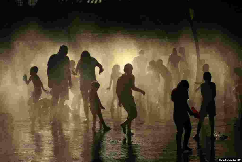 People cool off on an urban beach in Madrid, Spain. (AP/Manu Fernandez)
