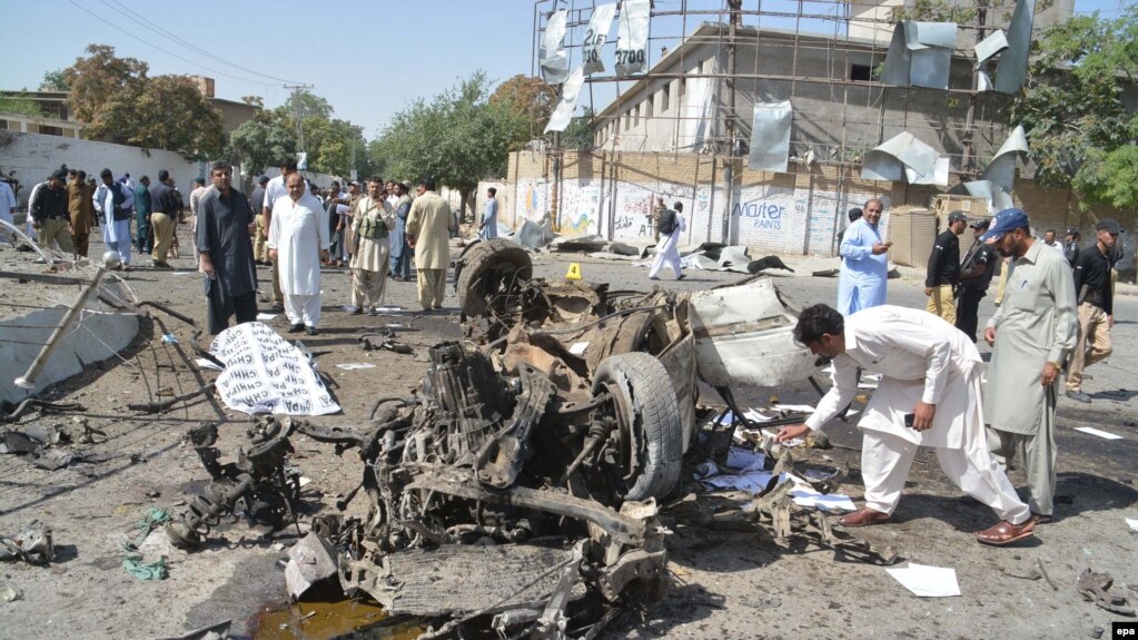 Pakistani security officials inspect the scene of a blast near the inspector-general of police office in Quetta on June 23.