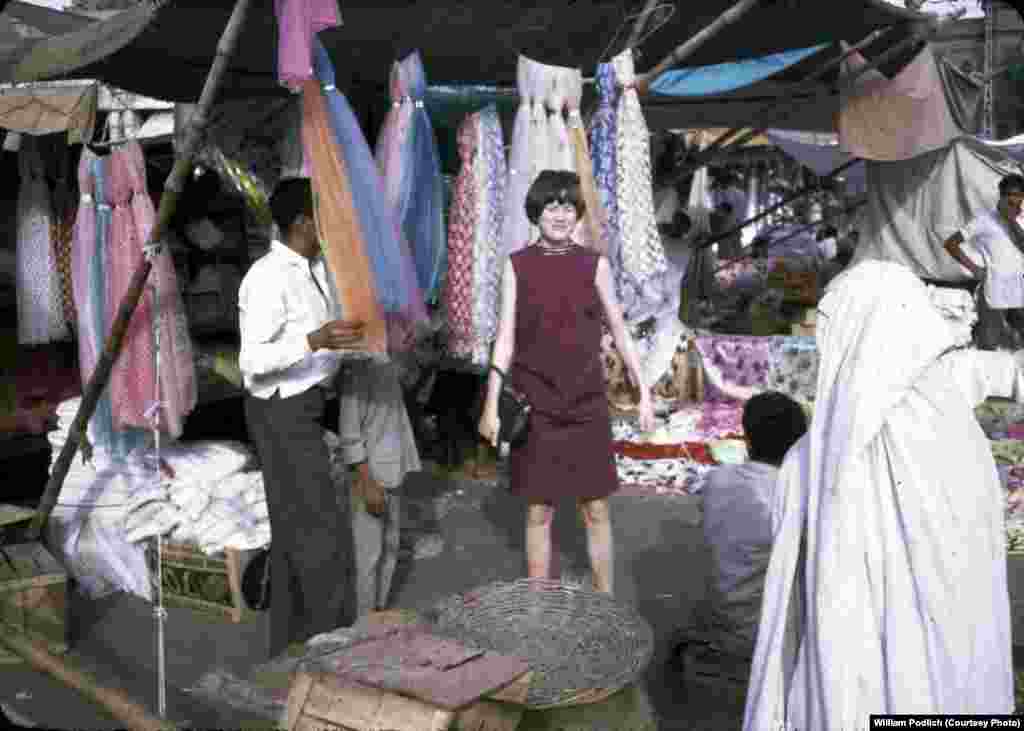 Jan Podlich is pictured during a shopping trip to Istalif, a village about 30 kilometers northwest of Kabul. &quot;We arrived in Kabul one sunshiny morning in June.... My dad met us and was able to whisk us through the customs. We proceeded into Kabul in a UN &#39;kombi&#39; (kind of an old-school SUV). I was tired, but I can remember being amazed at the sight of colorful (dark blue, green, and maroon) ghosts that were wafting along the side of the road. My dad explained there were women underneath those chadris and that some women had to wear them out in public. We never called the garments burqas.&quot;