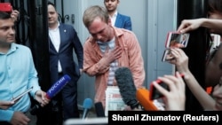 Russian journalist Ivan Golunov gestures to reporters after being released from police custody on June 11. 