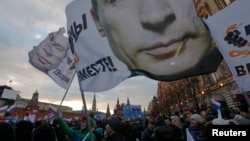 People attend a rally called "We are together" to support the annexation of Ukraine's Crimea to Russia in Red Square in central Moscow on March 18.