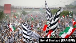 Supporters of opposition political parties wave party flags in Islamabad on November 1.
