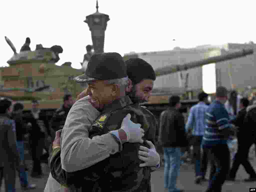 A man hugs an army commander in Cairo's Tahrir Square on February 12, the morning after Mubarak's resignation.