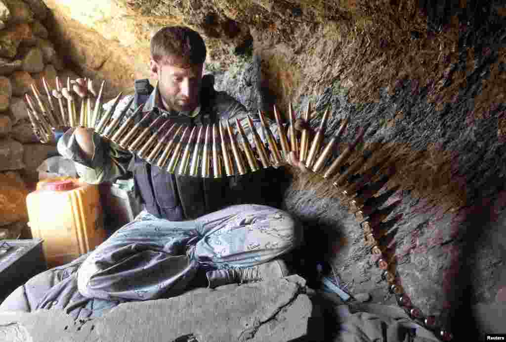 An Afghan border policeman prepares ammunition at a check post in the Goshta district of Nangarhar Province. (Reuters/Parwiz)