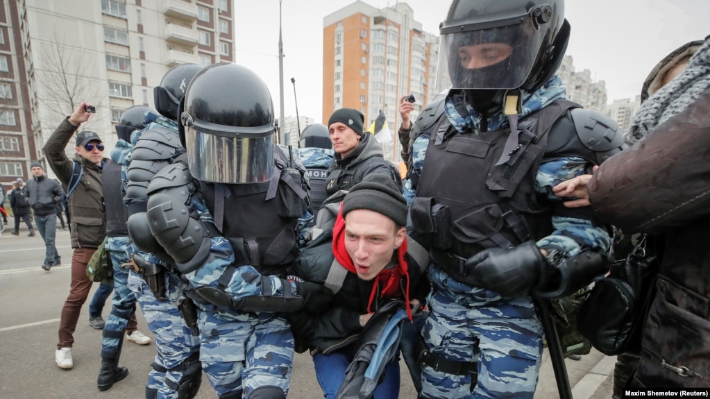 Police detain protesters at the nationalist march in Moscow. 