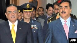 Pakistani President Asif Ali Zardari (left) is flanked by Prime Minister Yousuf Raza Gilani (right) for a meeting of coalition partners in Islamabad on January 16.