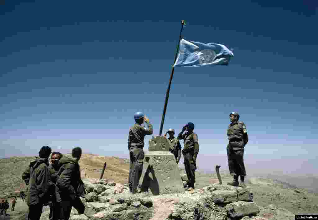 Austrian soldiers raise the UN flag on Mount Hermon in the buffer zone between Syria and Israel following the withdrawal of Israeli forces in 1974. It remains the highest manned UN position in the world today.&nbsp;