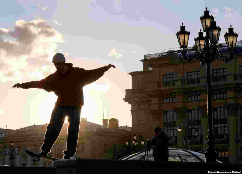 A skateboarder performs a trick in Manezh Square in central Moscow. (Reuters/Evgenia Novozhenina)