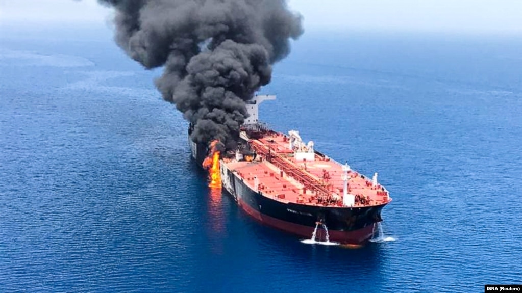 Smoke rises from an oil tanker in the Gulf of Oman after an explosion hit the vessel.