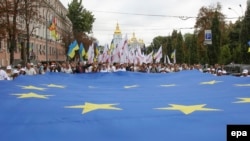 People carry a giant EU flag during a parade to mark Ukrainian Independence Day in downtown Kyiv in August.