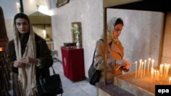 An Iranian Christian women lights candles in a church in Tehran. (file photo)