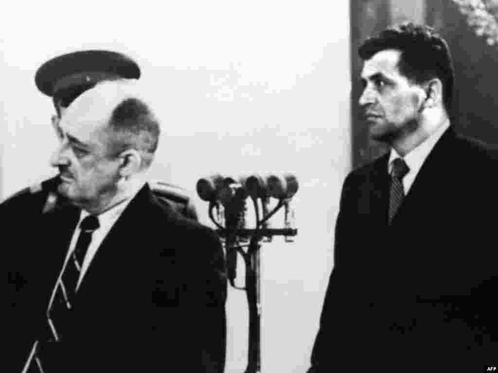 Powers (right) listens to the verdict being read on August 20, 1960. Powers pleaded guilty and was convicted. He was handed a 10-year sentence and was expected to serve the first three years in jail and the remainder in a labor camp. &nbsp;