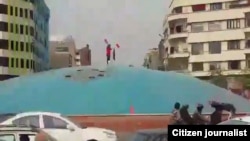 A video-grab shows of a woman who took off her scarf in the middle of Revolution Square, reportedly on October 29.