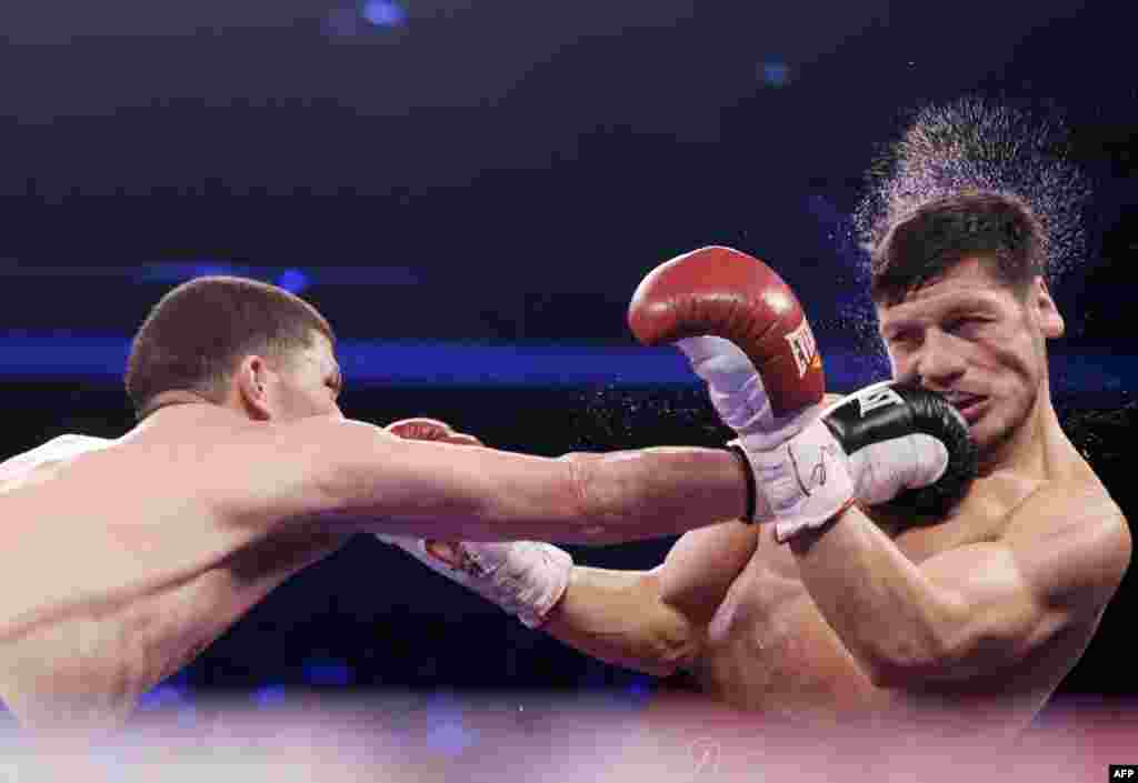 Puerto Rico&#39;s Roman Martinez (left) punches Diego Magdaleno of the United States during their WBO world super featherweight title bout in Macau. Martinez won in a split decision. (AFP/Dale de la Rey)