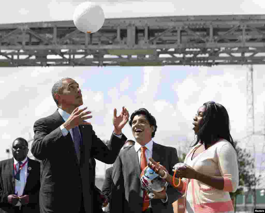 U.S. President Barack Obama heads a soccer ball at the Ubungo Power Plant in Dar es Salaam, Tanzania. The ball has internal electronics that allow it to generate and store electricity to power small devices. (Reuters/Jason Reed)