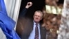 Serbian nationalist leader Vojislav Seselj waves at supporters after arriving at his Serbian Radical Party (SRS) headquarters in Zemun, near Belgrade, on November 12.