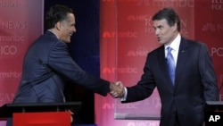 Mitt Romney (left) and Rick Perry shake hands after a debate in September.
