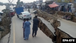 A damaged road caused by an earthquake is seen in Mirpur, in Pakistani-administered Kashmir, on September 24.