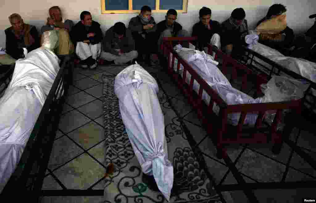 People gather around victims during a funeral service at a Quetta mosque.