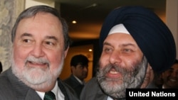 India's acting UN ambassador, Manjiv Singh Puri (right), congratulates Pakistan's UN Ambassador Abdullah Hussain Haroon upon Islamabad's election to the UN Security Council on October 21.