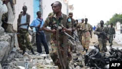 Somali National Government soldiers at the scene after Al-Qaeda-linked Shebab insurgents blasted their way into the UN compound in Mogadishu on June 19.