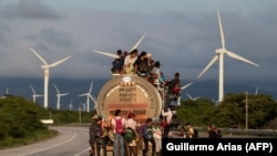 MEXICO -- A truck carries mostly Honduran migrants taking part in a caravan heading to the US, passes by a wind farm on their way from Santiago Niltepec to Juchitan, near the town of La Blanca in Oaxaca State, October 30, 2018