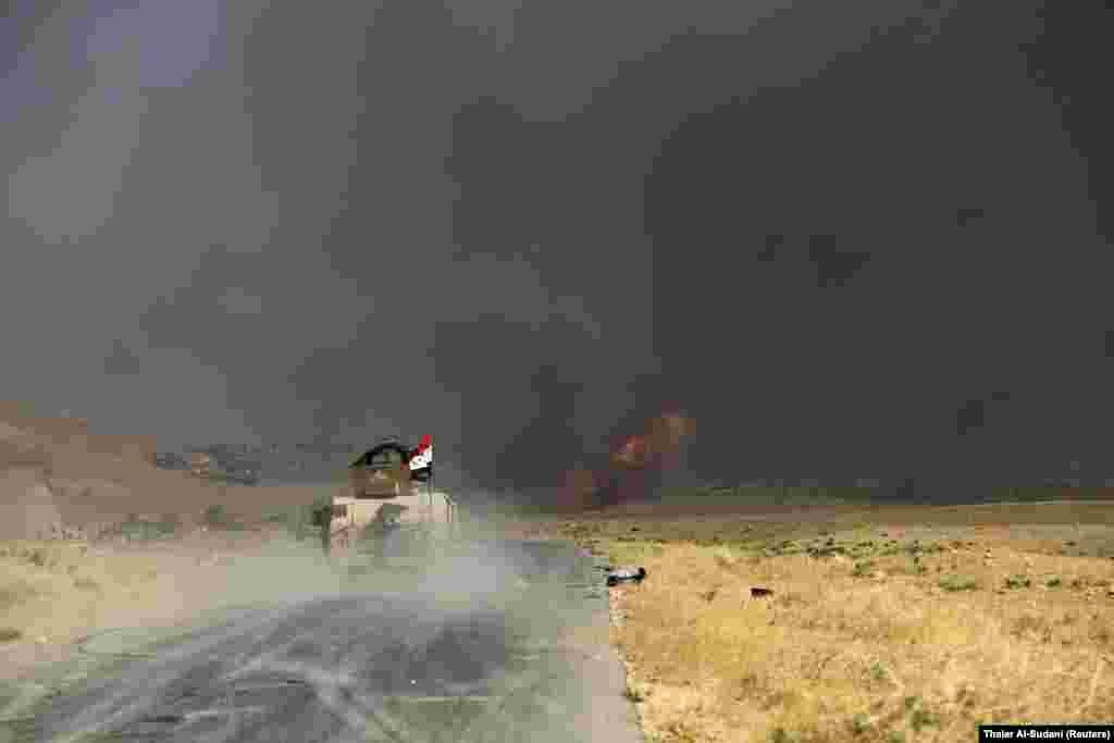 Smoke rises from a car-bomb attack during fighting between the Iraqi Army and Shi'ite Popular Mobilization Forces (PMF) against Islamic State militants in Al-Ayadiya, northwest of Tal Afar, Iraq. (Reuters/Thaier al-Sudani)
