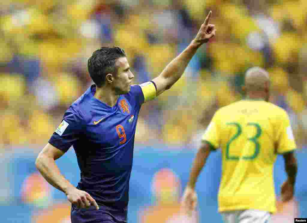 Robin van Persie of the Netherlands celebrates after scoring a goal from a penalty kick during their 2014 World Cup third-place playoff against Brazil at the Brasilia national stadium in Brasilia