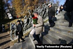 People attend a ceremony commemorating victims of the Minsk ghetto and marking the 75th anniversary of its liquidation at the "Yama" (Pit) monument to the Holocaust victims in Minsk on October 22, 2018.
