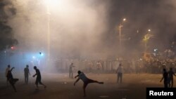 Armenia - Demonstrators who had gathered in a show of support for gunmen holding several hostages in a police station, clash with riot police in Yerevan, Armenia, July 20, 2016