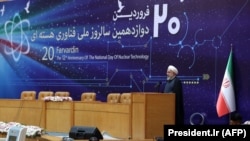 IRAN -- Iranian President Hassan Rohani (R) speaks during a ceremony to mark National Nuclear Technology Day in Tehran, April 9, 2018