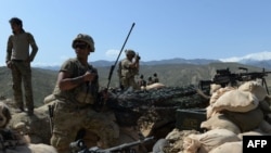 FILE: U.S. soldiers take up positions during an operation against the Islamic State (IS) militants in Nangarhar province.